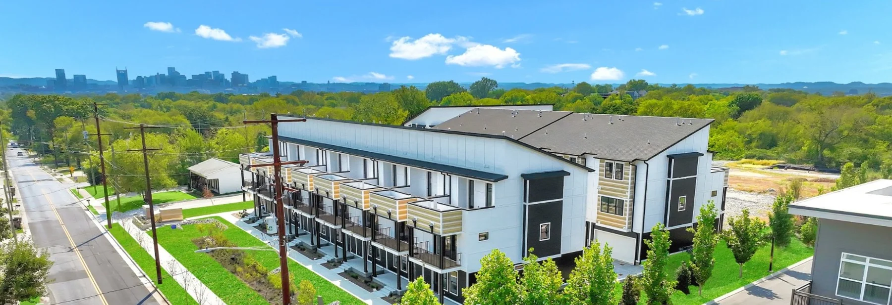 Completed townhome buildings along Lischey Avenue with the Nashville skyline beyond